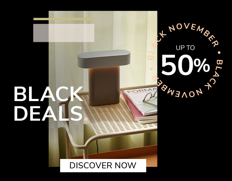 Discover More Elegant designer table lamp on natural stone base with gold stem and white shade, promoting Black November sale – up to 40% off with text ‘First Black Deals’ and ‘Discover More’ button.