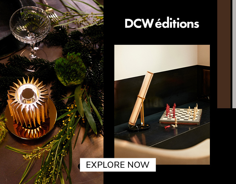 Explore now Elegant DCW éditions lighting displayed on a festive table and beside a chessboard, featuring modern sculptural lamps in warm tones with text ‘Explore Now’.